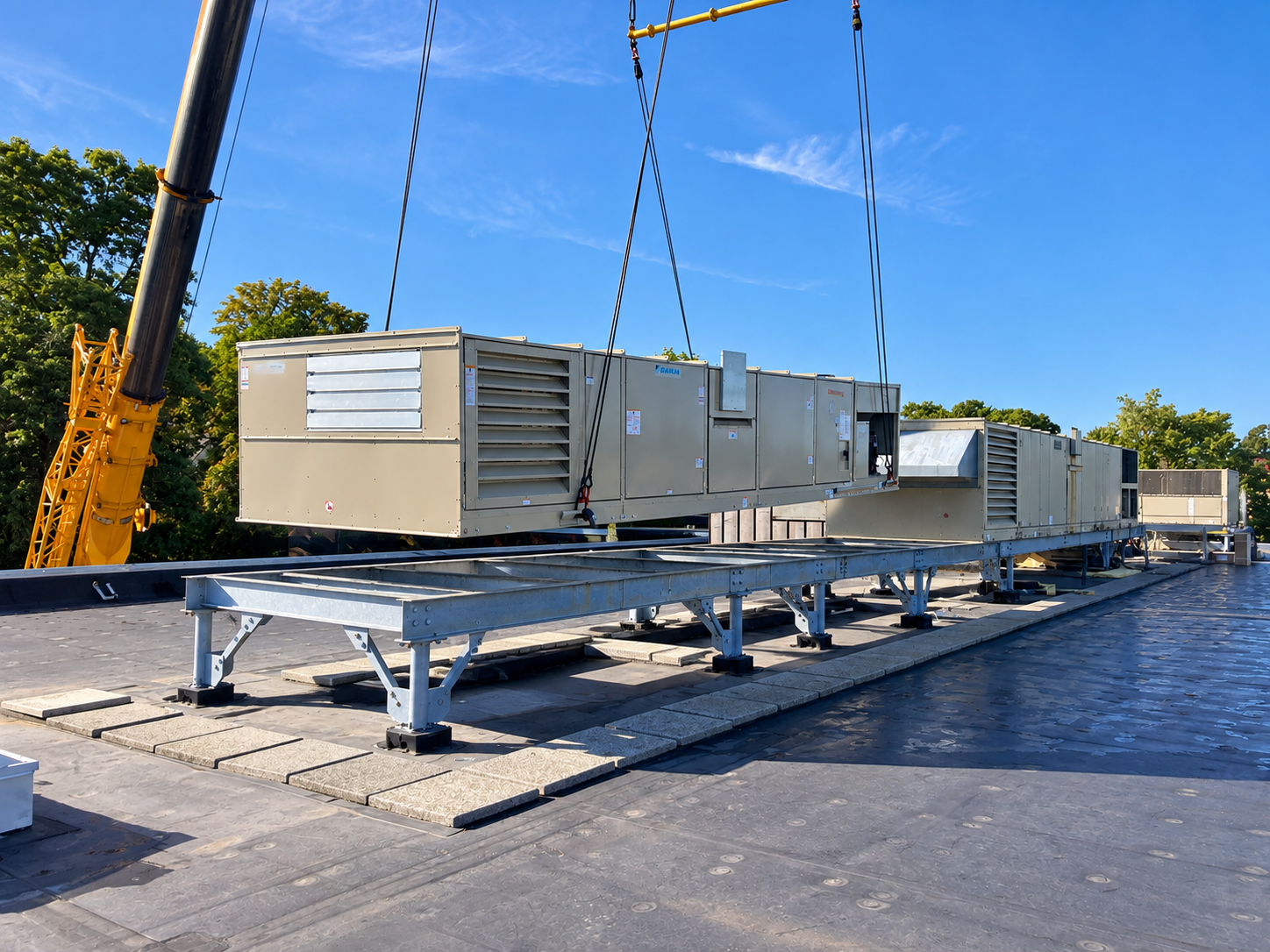 Crane setting commercial rooftop HVAC equipment